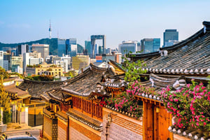 Old traditional Korean Village framed by new high-rise buildings 